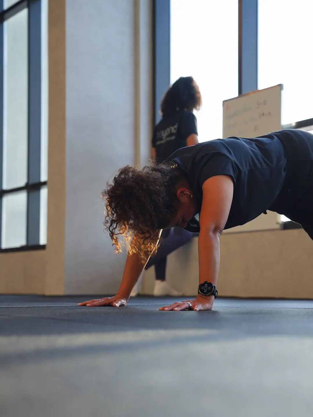 A member working through a mobility position on the floor