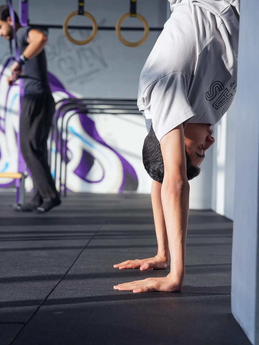 A member pressing into a handstand