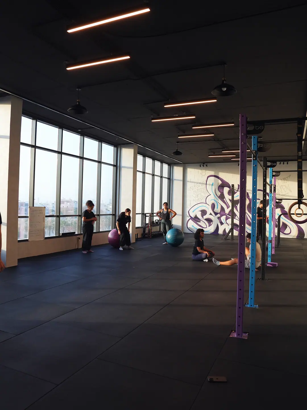 The academy's training hall, lit by its window wall